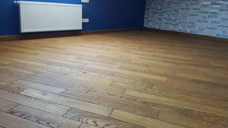 An apartment with hardwax oil finished hardwood flooring running at a 45 degree.