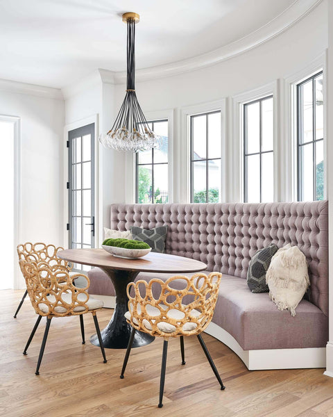 Dining area with hardwood flooring in custom home with bench seating on a curved wall.