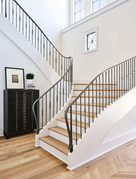 Large custom staircase in custom home with white oak flooring.