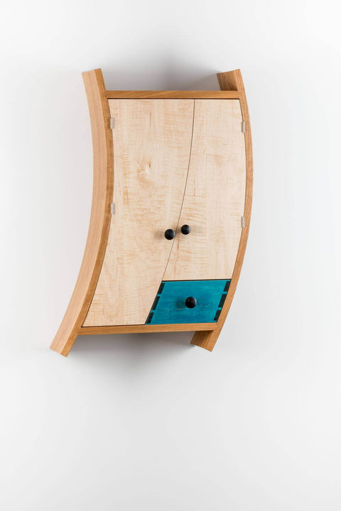 Wooden liquor cabinet made from multiple wood species is finished with Rubio Monocoat.