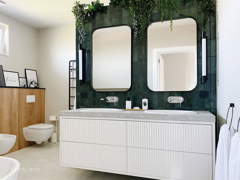 Bold tiles behind a bathroom vanity.