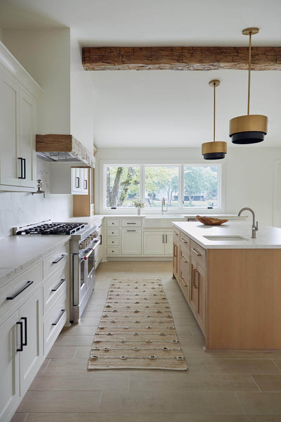 Bright white kitchen with natural wood accents.