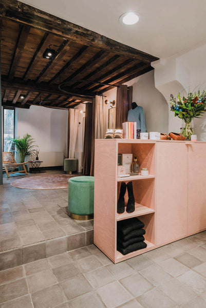 Rose gold wood clothing store display rack.