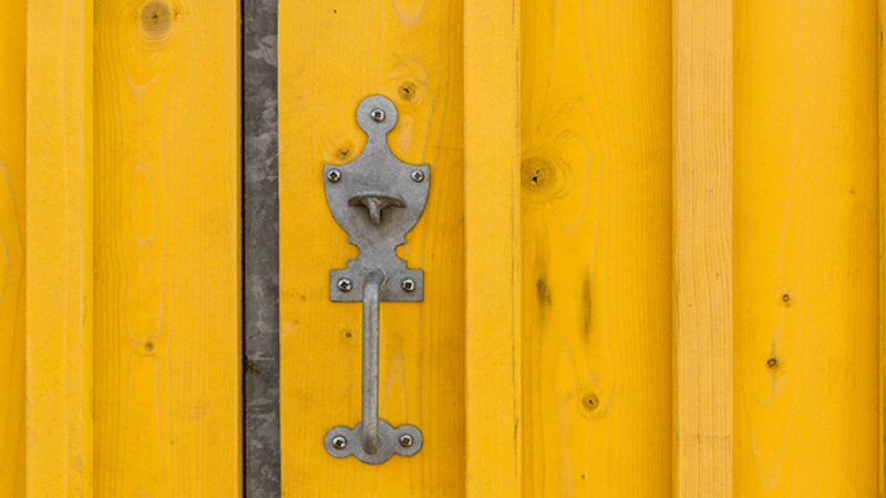 A yellow exterior building wall finished using hardwax oil form Rubio Monocoat.