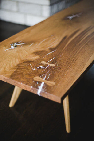 Solid white oak coffee table with a matte wood finish, white epoxy, and bowties.