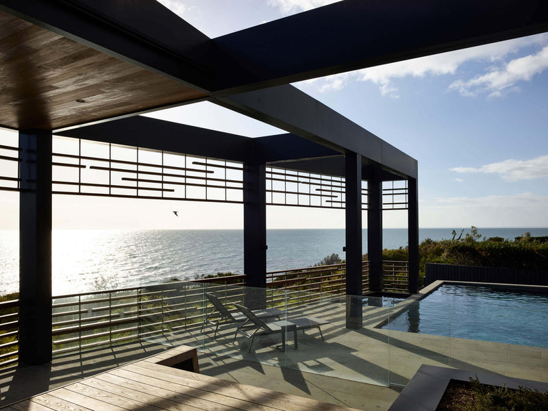 Wooden patio and pool area at a vacation home.