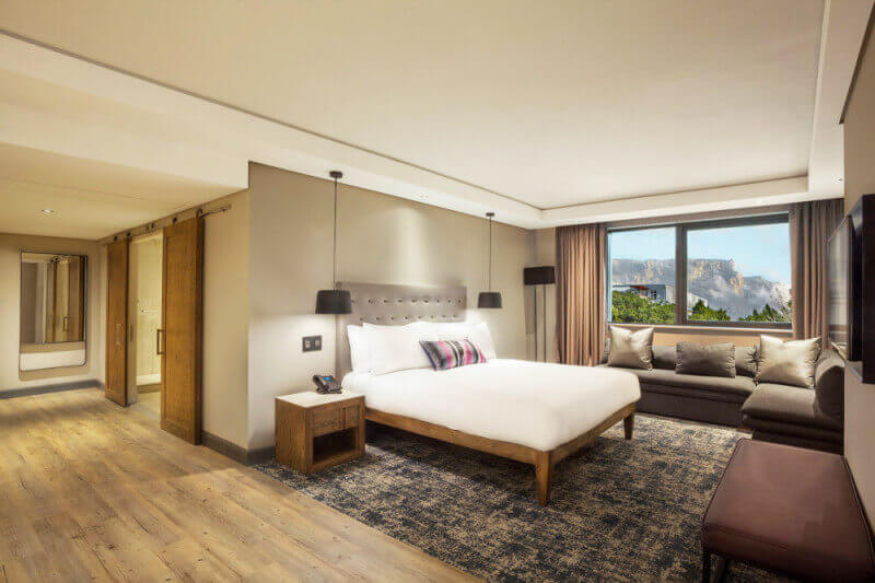 A hotel room with wood flooring that has a durable hardwax oil wood finish on it.