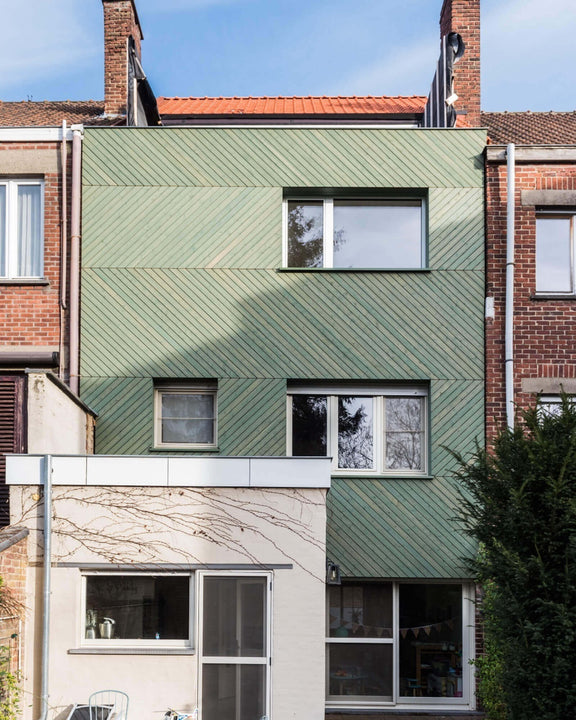 A building with green wood siding finished with Rubio Monocoat exterior wood finish.