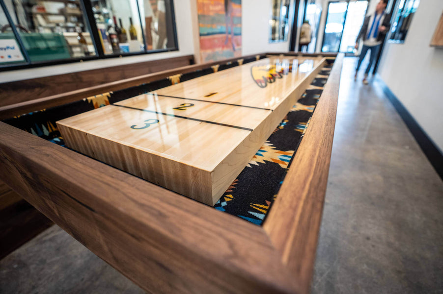 Detail shot of a walnut shuffle board table finished with Oil Plus 2C Pure.