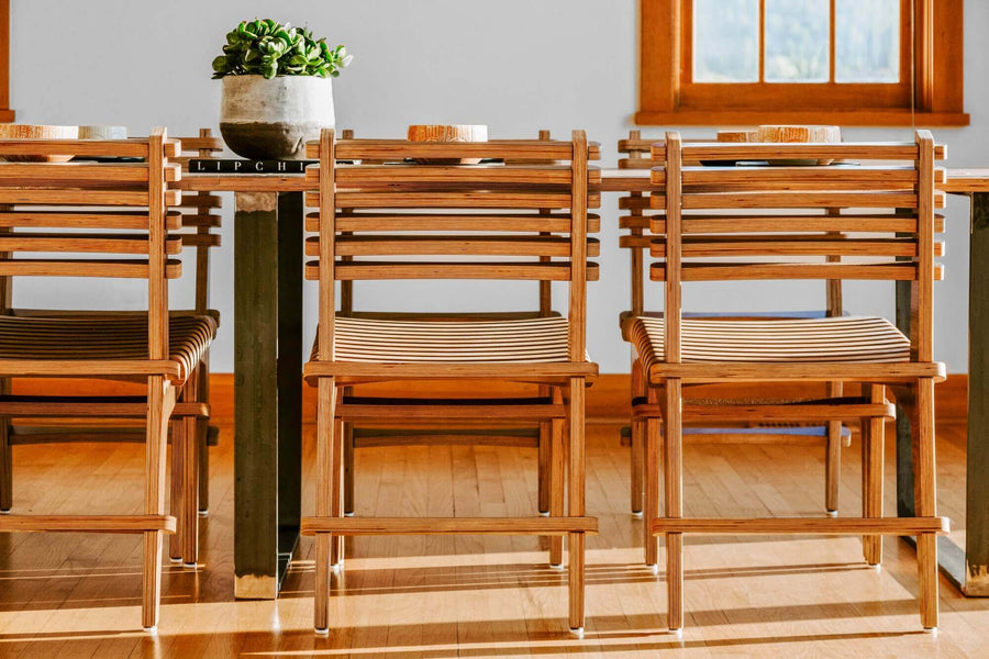 Dining table chairs made from responsibly sourced wood materials.