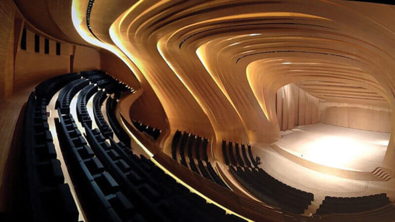 A large wooden auditorium with curving wood panels designed to be acoustically beneficial.