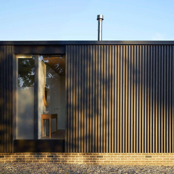 Exterior wood slatted cladding with a large floor to ceiling window finished with Rubio Monocoat hardwax oil finish.