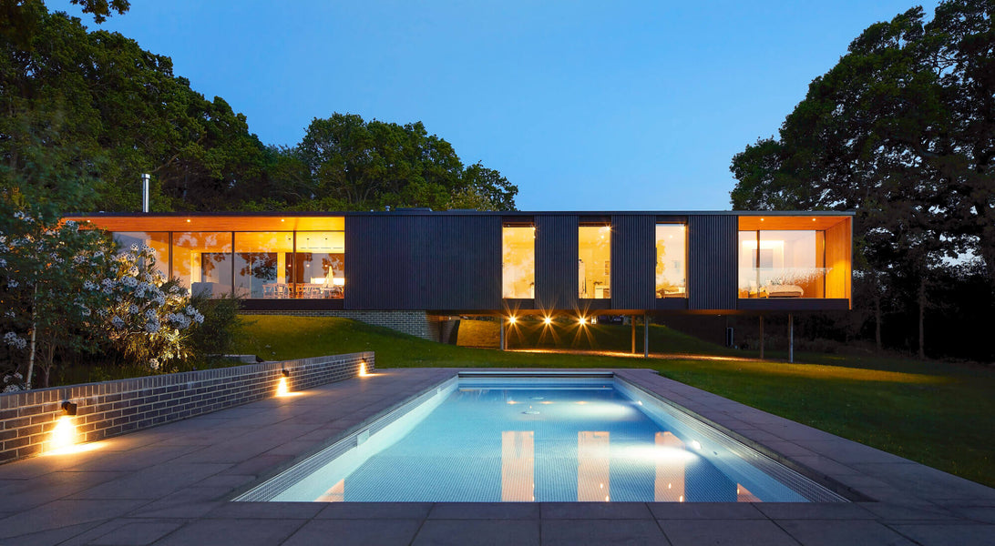 Modern vacation home with a large rectangular pool.