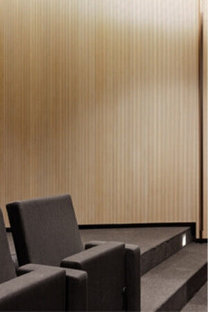 A wall of acoustically treated wood panels finished with hardwax oil wood finish.