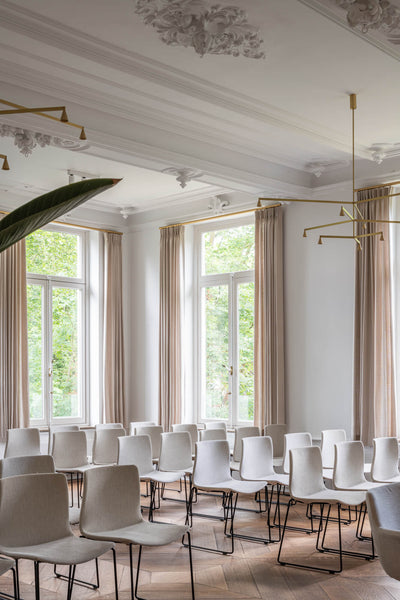 A room set up seminar style with stunning wood flooring finished with a wax wood finish.