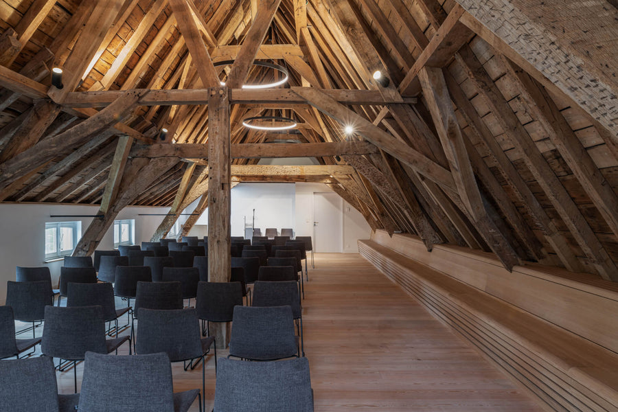 Exposed beams in a room with hardwood flooring finished with hardwax oil.
