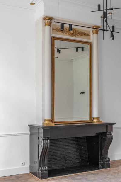 A stone fireplace on in a room with a stunning parquet flooring finish with Rubio Monocoat products.
