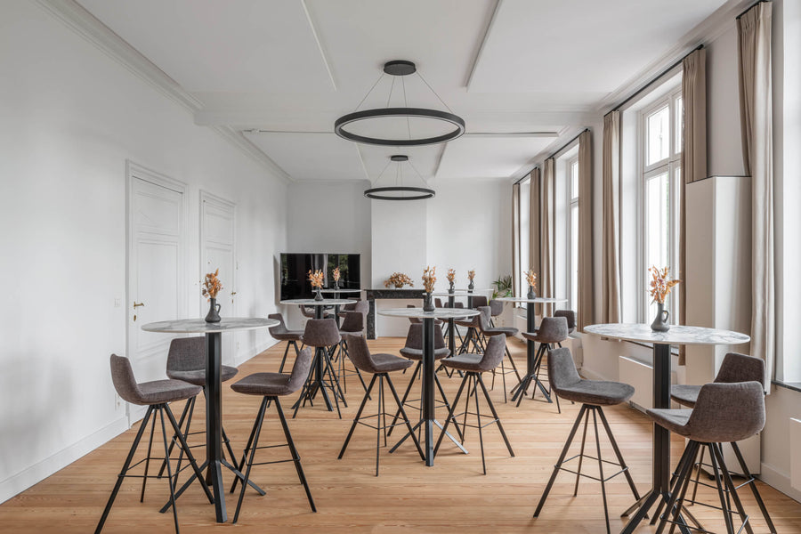 A bistro table set up in a room with renovated hardwood flooring.