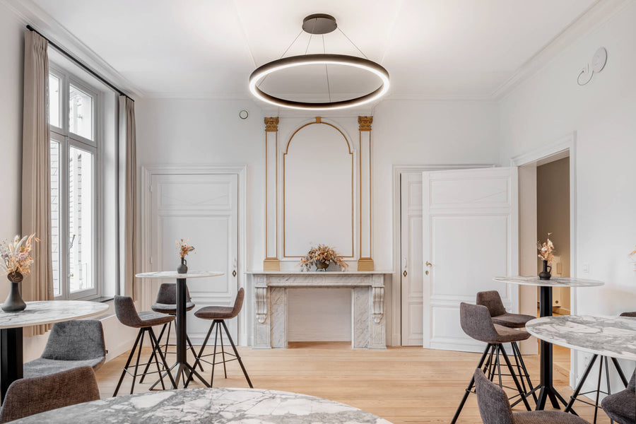 A lovely room with refinished wood flooring and bar height tables. A marble fireplace is the centerpiece of this space.
