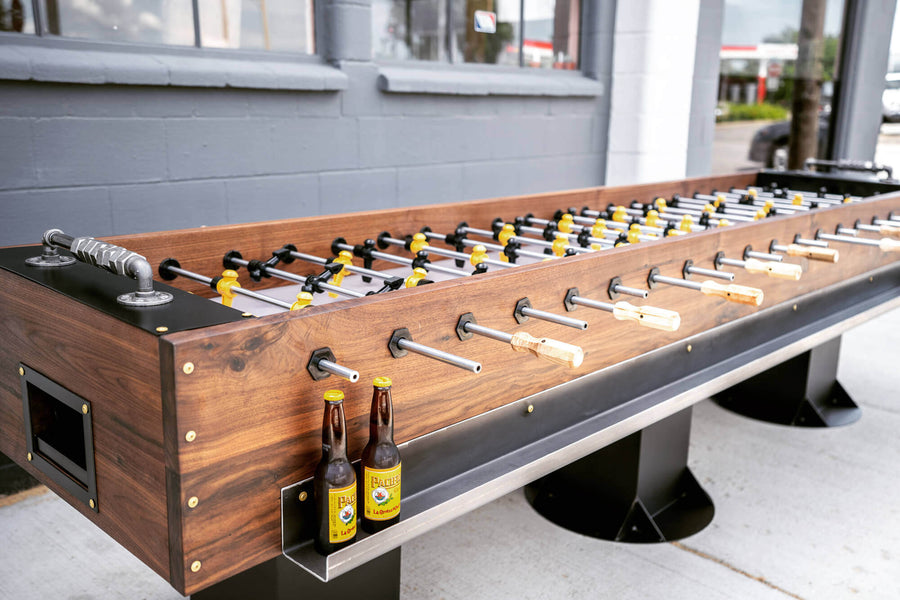 A foosball table that can hold up to ten people made from walnut and finished with Oil Plus 2C.