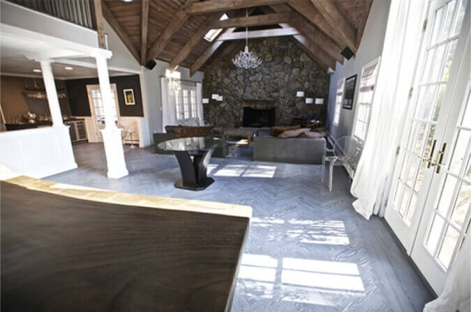 A living area in a home with herringbone wood floors.