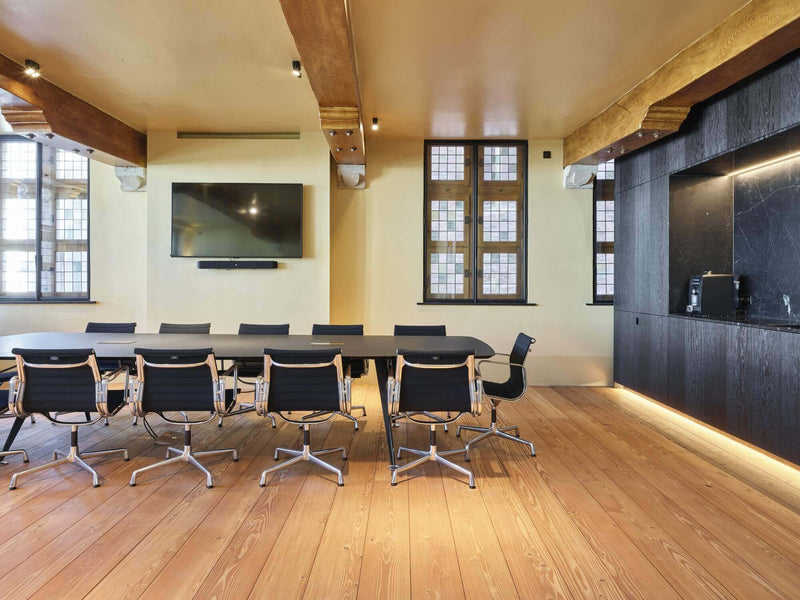 Matte wood floors in an office conference room.
