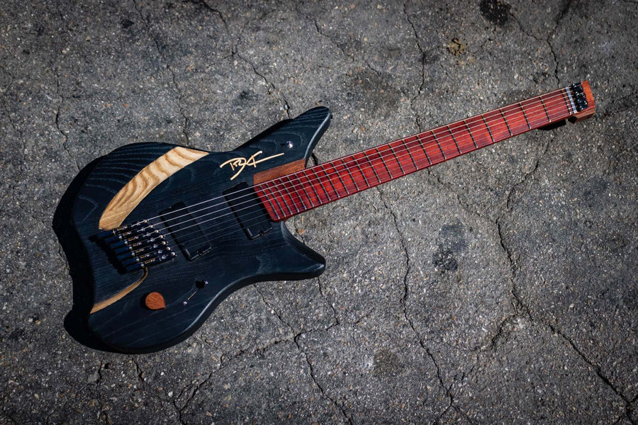 7 string guitar with dark black finish on it.