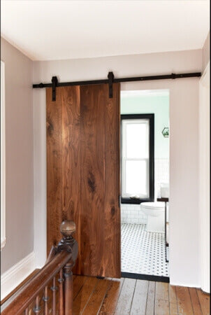 A salvaged black walnut track door that was recently remodeled.