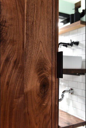 Detail shot of a salvaged black walnut barn door finished using Rubio Monocoat Oil Plus 2C