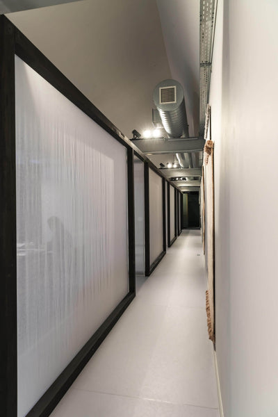 Long hallway in new office design with dark wood borders.
