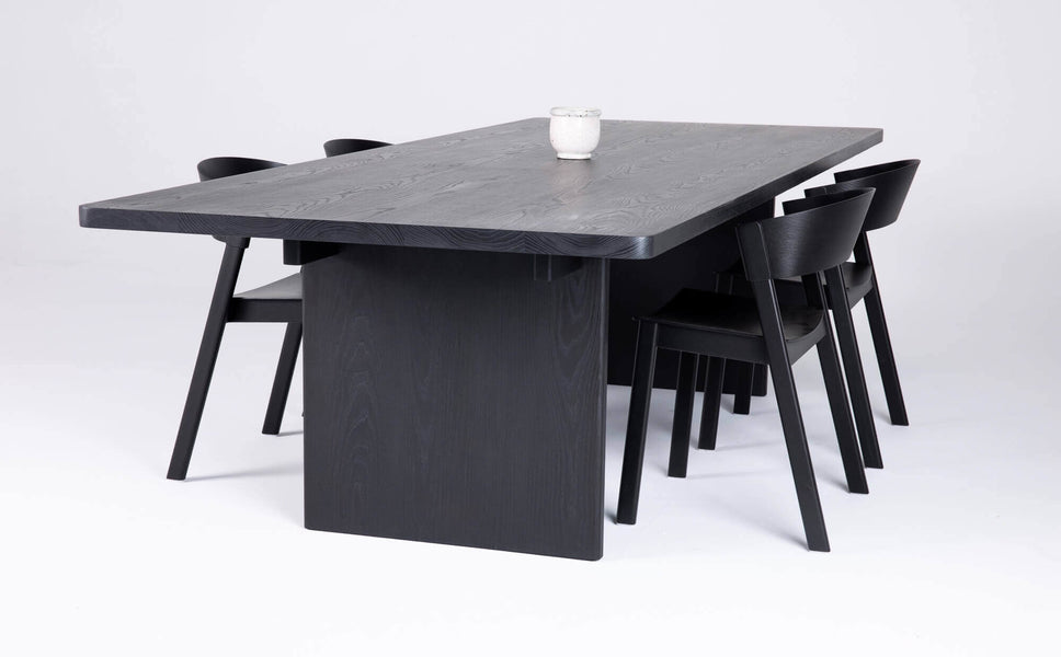Side view of a black stained ash dining table