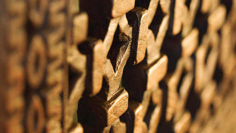Close details of hand-carved cabinet faces.